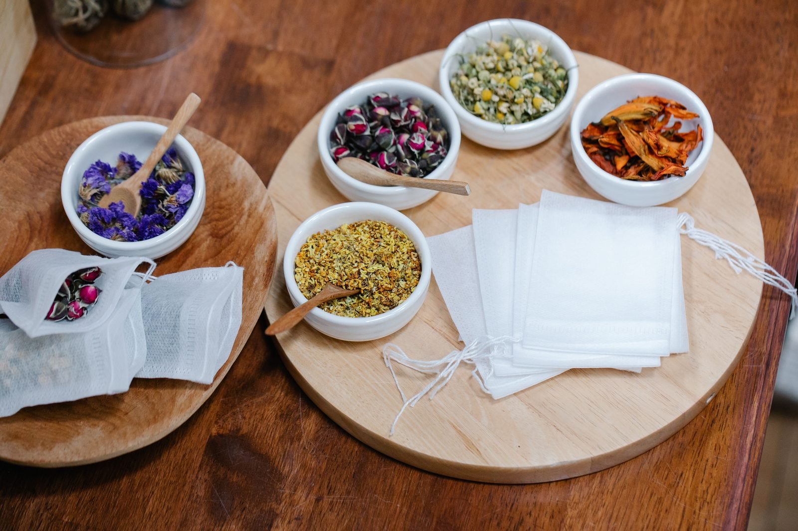 Bowls of dried rose, chamomile, calendula and cornflower for blending